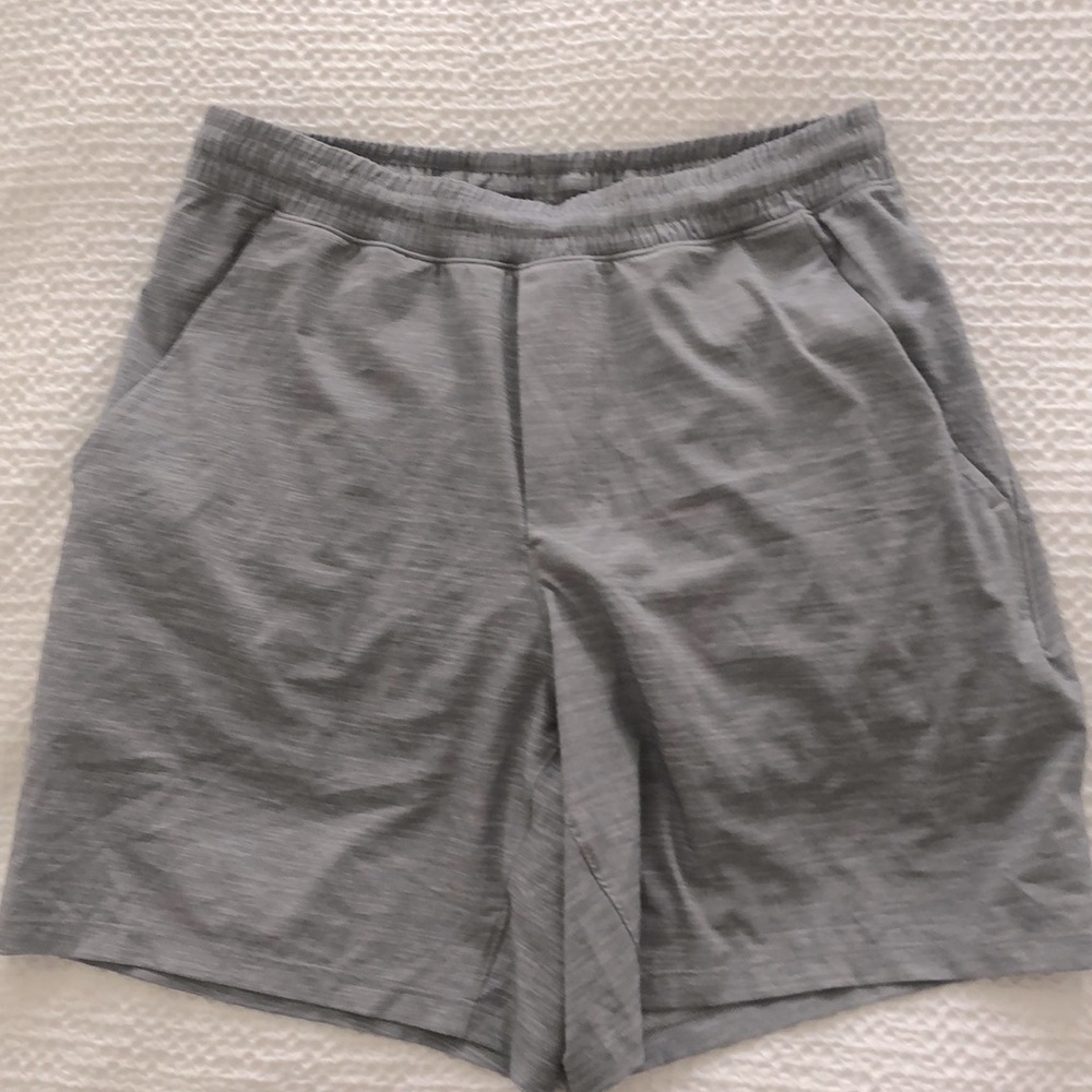 Men's Lululemon Grey Shorts. Spandex lined w/side pockets + extra zipped pocket.